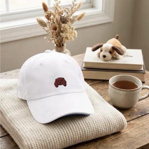 May include: A set of three ceramic mugs with a speckled, matte finish. Each mug features a different color: light blue, cream, and gray. The mugs have a simple, modern design with a rounded shape and a comfortable handle.