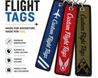 May include: Three rectangular fabric keychains with metal rings, featuring embroidered designs in blue, red, and olive green. The blue tag shows an airplane, the red tag displays wings with a star, and the olive tag depicts mountain peaks.