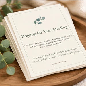 May include: A stack of cream-colored prayer cards featuring a small green eucalyptus sprig illustration at the top. The text reads: Praying for Your Healing, May God's peace and comfort surround you, and Jeremiah 17:14.