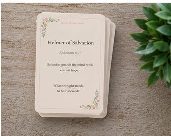 May include: A stack of rectangular cards with rounded corners, featuring a cream background and floral accents in the corners. The top card displays the text Armor of God Cards, Helmet of Salvation, Ephesians 6:17, and a short inspirational message.