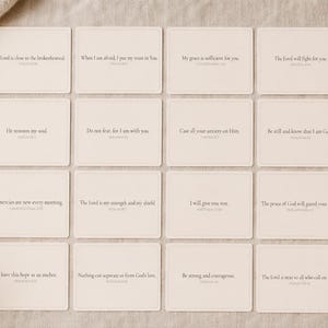 May include: A collection of sixteen square cards with inspirational quotes in a light beige color. The cards are arranged on a neutral-toned surface, with a cup of coffee and decorative elements in the background. Each card features a different quote in a simple, elegant font.