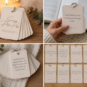 May include: A set of cream-colored prayer cards held together by a metal ring. Each rectangular card features black printed text with various evening prayers and scripture references. The cards have rounded corners and a simple border design.
