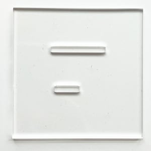 May include: A clear, square acrylic display stand with two rectangular, raised supports. The supports are positioned horizontally, one near the top and one near the bottom of the stand. The stand is designed to hold small items.