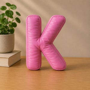 Close-up view of 3D rounded puffy letter STL models for 3D printing. Digital files shown as a colorless mesh to illustrate the 3D printable structure and smooth surface finish.