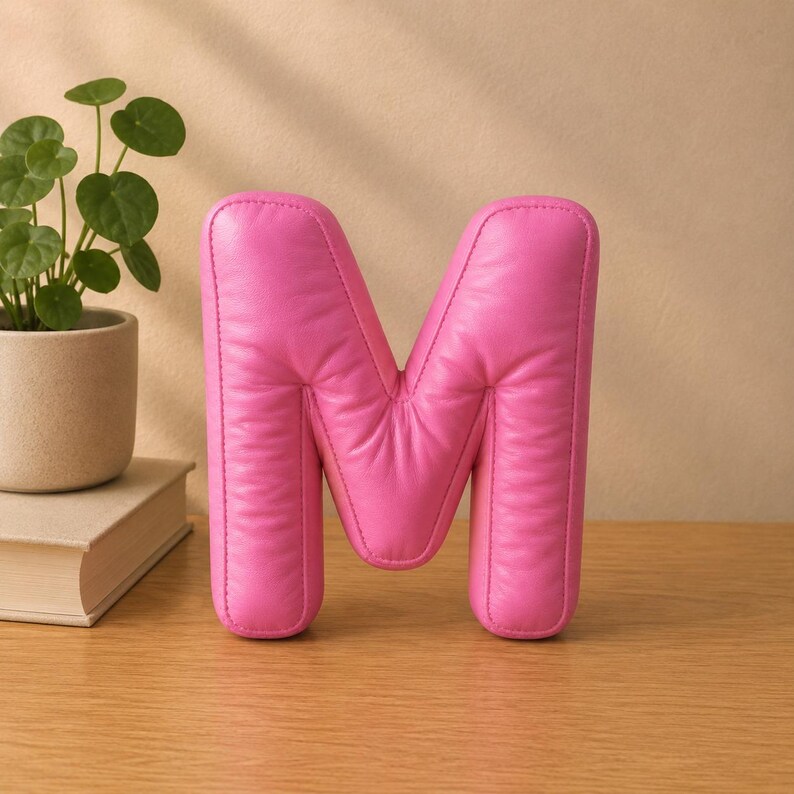 Close-up view of 3D rounded puffy letter STL models for 3D printing. Digital files shown as a colorless mesh to illustrate the 3D printable structure and smooth surface finish.