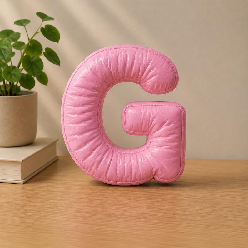 Close-up view of 3D rounded puffy letter STL models for 3D printing. Digital files shown as a colorless mesh to illustrate the 3D printable structure and smooth surface finish.