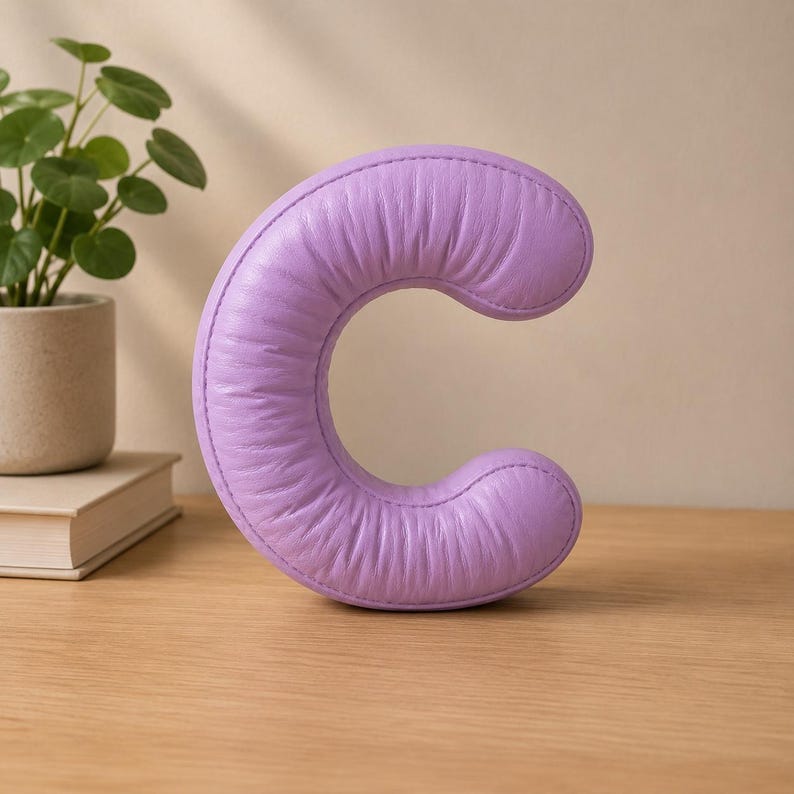 Close-up view of 3D rounded puffy letter STL models for 3D printing. Digital files shown as a colorless mesh to illustrate the 3D printable structure and smooth surface finish.