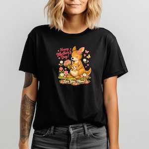 May include: Black t-shirt featuring a cartoon kangaroo and joey surrounded by flowers. The design includes the text "Happy Mother's Day!" and "Love You, Mom!" in pink and green. The kangaroo is brown with a pink flower on its head.