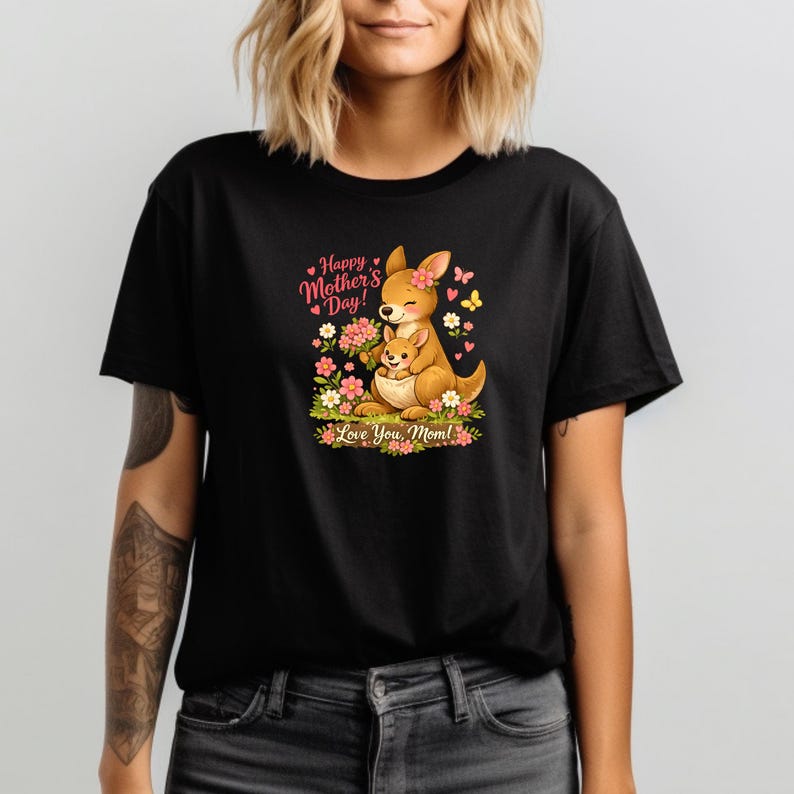 May include: Black t-shirt featuring a cartoon kangaroo and joey surrounded by flowers. The design includes the text "Happy Mother's Day!" and "Love You, Mom!" in pink and green. The kangaroo is brown with a pink flower on its head.