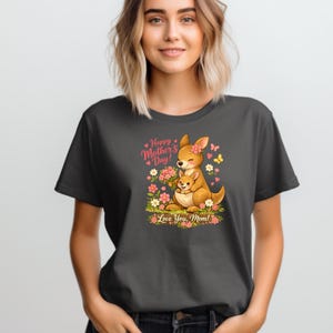 May include: Dark gray t-shirt featuring a cartoon kangaroo with a joey, surrounded by flowers and butterflies. The text reads "Happy Mother's Day! Love You, Mom!" in pink and green.