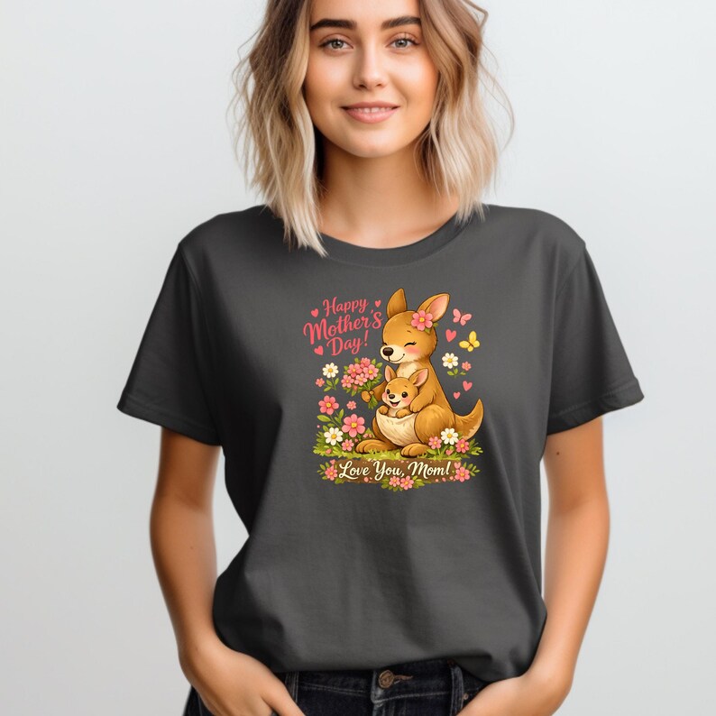 May include: Dark gray t-shirt featuring a cartoon kangaroo with a joey, surrounded by flowers and butterflies. The text reads "Happy Mother's Day! Love You, Mom!" in pink and green.