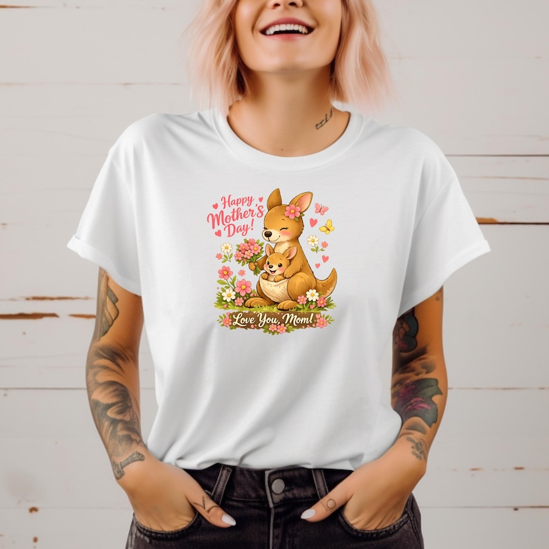 May include: White t-shirt featuring a cartoon kangaroo with a joey, surrounded by flowers and butterflies. The design includes the text "Happy Mother's Day!" and "Love You, Mom!" in pink and green.