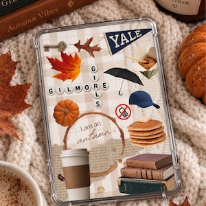 May include: A clear tablet case featuring a collage of autumn-themed icons including a Yale pennant, a stack of pancakes, a coffee cup, a black umbrella, a pumpkin, a blue baseball cap, a no-mobile sign, and the text Gilmore Girls.