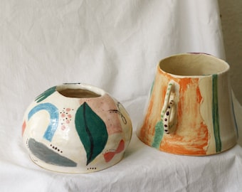 two beautifully illustrated ceramic vases