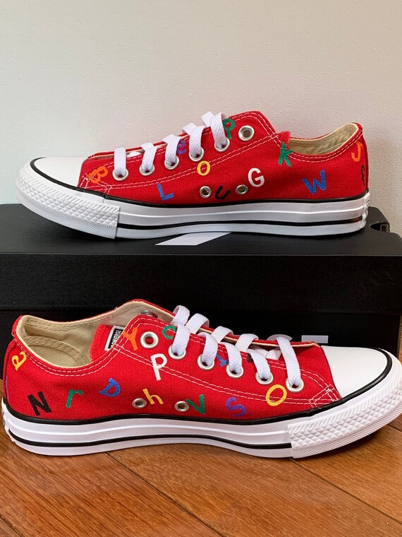 White converse top with red letters