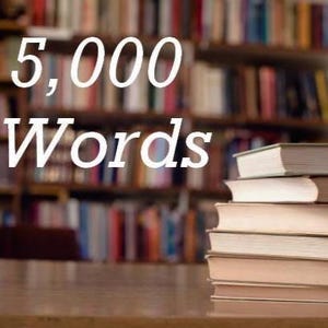 May include: Image features the text "5,000 Words" in white against a blurred background of bookshelves filled with books. A stack of books is on a wooden surface in the foreground.