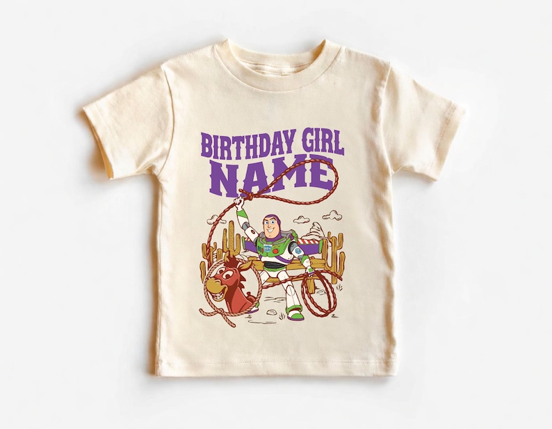 Personalized Sheriff Shirt, Custom Deputy Name T-Shirt, Space Ranger Cowboy Tee, Kids Western Birthday Gift, Toddler Buzz Lightyear Shirt

Step into an adventure-filled world for your little hero! This custom-designed t-shirt blends a beloved space-themed character with a fun western twist, sparking your child's imagination. It is the perfect outfit for birthday parties and a stylish choice for everyday playtime.