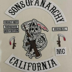 May include: A collection of embroidered patches. The main patch reads "Sons of Anarchy" in a curved banner. Other patches include "California", "Unholy Ones", "Redwood", "Men of Mayhem", "Original", and "MC". The central patch shows a grim reaper with a rifle.