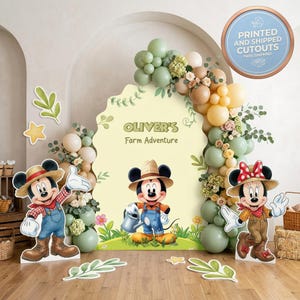 May include: A decorative party backdrop featuring a large scalloped arch with the text Oliver's Farm Adventure, surrounded by balloon garlands in sage green, beige, and yellow, with cutouts of cartoon mice in farm attire and leaf accents.