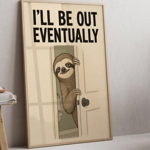 May include: A rectangular wall art print featuring a cartoon illustration of a brown sloth peeking from behind a white door. The text I'LL BE OUT EVENTUALLY is printed in bold black capital letters at the top of the cream-coloured background.