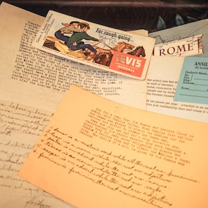 May include: A collection of vintage paper ephemera including a Levi's advertisement with the text For rough going, a blue Annual Membership card, a handwritten Latin exercise on cream paper, and an orange card with typed grammatical notes.