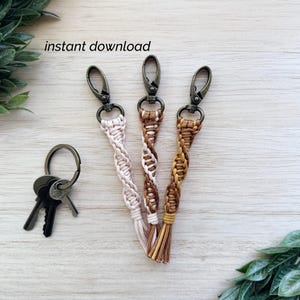 May include: Three macrame keychains in beige, brown, and tan with metal clasps. One keychain has a tassel. The text "instant download" is visible. Keys are also present.