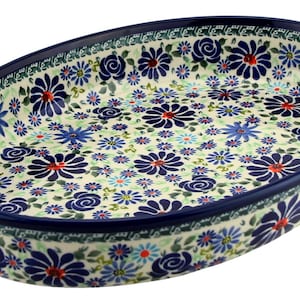 May include: Oval ceramic serving dish with a blue floral pattern. The dish features a dark blue rim and is decorated with blue, red, and white flowers. The interior is filled with a repeating floral design.