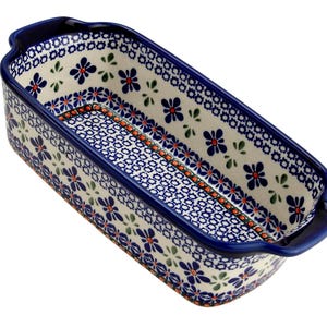 May include: Rectangular ceramic baking dish with blue floral and geometric patterns. The dish has a dark blue rim and handles, with a cream-colored background. The interior features a detailed blue and white design, perfect for baking and serving.