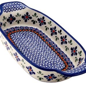 May include: Oval ceramic baking dish with a blue floral pattern and a blue rim. The dish has a white background with blue and orange accents. The handles are blue and the dish is approximately 12 inches long.
