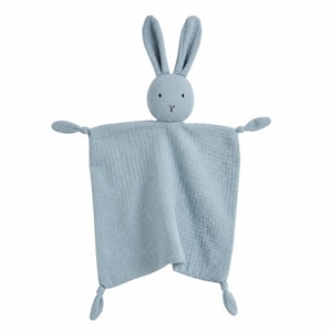 May include: A light blue muslin security blanket featuring a plush rabbit head with long ears and embroidered facial features. The square fabric body has four corners, each tied into a small knot, creating a soft, textured, and lightweight item.