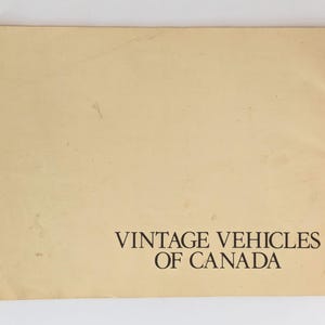 May include: A vintage, off-white booklet with the text "Vintage Vehicles of Canada" printed in black on the bottom of the cover.