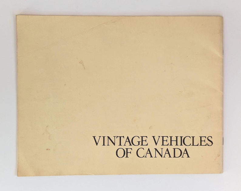 May include: A vintage, off-white booklet with the text "Vintage Vehicles of Canada" printed in black on the bottom of the cover.