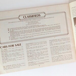 May include: A vintage car classifieds section from a magazine. The page features a list of cars for sale, including makes and models, years, and contact information. The text is in black and white, and the page is bordered by a black line.