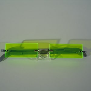 Stretched rectangle rimless cosplay costume glasses.