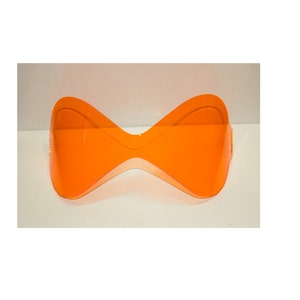 May include: A pair of orange safety glasses with a butterfly-shaped frame.