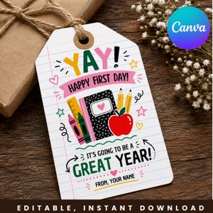 May include: A white rectangular gift tag with a lined paper background featuring colorful school-themed illustrations including a notebook, pencils, crayons, and an apple. Text reads YAY! HAPPY FIRST DAY! IT'S GOING TO BE A GREAT YEAR! FROM, YOUR NAME.