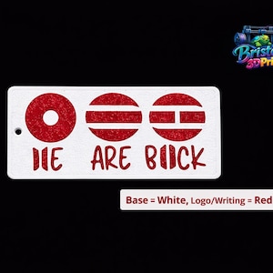 May include: White rectangular sign with red graphic circles and horizontal lines, and the words "WE ARE BACK" in red. The sign has a small hole on the left side. The background is black.