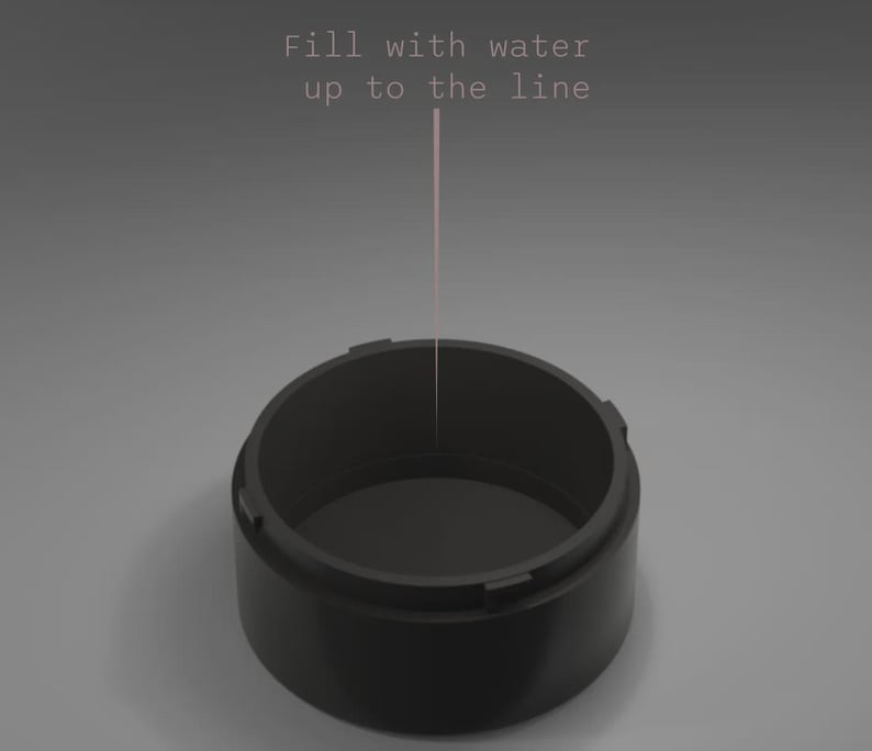 May include: A black, cylindrical container with a wide opening. The text "Fill with water up to the line" is displayed above the container, with a pink line indicating the fill level. The container is set against a gray background.