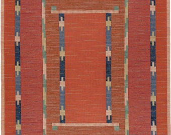 May include: A rectangular area rug featuring a central solid orange panel surrounded by concentric borders. The design includes a dark blue frame with light blue and cream cross-shaped accents, set against a textured orange background.
