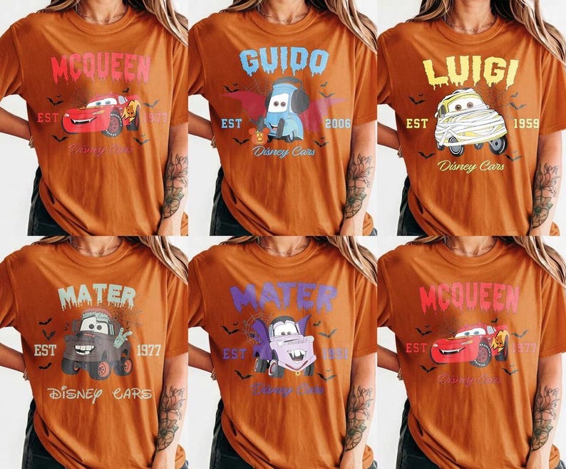 May include: Six orange t-shirts featuring Disney Cars characters. Each shirt has a different character name in a spooky font, with the character's image, the word "EST", and a year. The shirts are a Halloween theme.