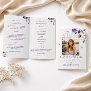 May include: A funeral program featuring a floral design with purple and blue wildflowers and butterflies. The front cover displays a photograph of a person, the text Celebrating the Life of Eleanor Whitmore, and dates. The interior lists an obituary.