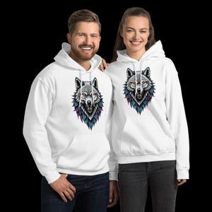 May include: White hooded sweatshirts featuring a detailed wolf head design. The wolf illustration has gray, blue, purple, and red accents. The sweatshirts have a front pocket and a drawstring hood.