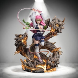 May include: A detailed anime-style figurine featuring a character with pink and green hair, wearing a dark blue uniform with a white jacket, holding a long, flexible sword. The figure is surrounded by three brown, dragon-like wooden structures.