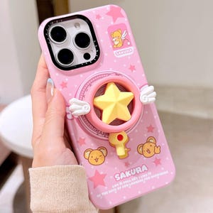 May include: A white ceramic mug with a black handle and the text "But First, Coffee" in a bold, black font. The mug is set against a blurred background, suggesting a cozy setting.