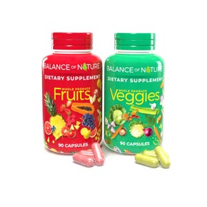 May include: Two supplement bottles, one red and one green, labeled "Fruits" and "Veggies" respectively. Each bottle has a red or green cap and contains 90 capsules. The red bottle features fruit illustrations, while the green bottle displays vegetables.