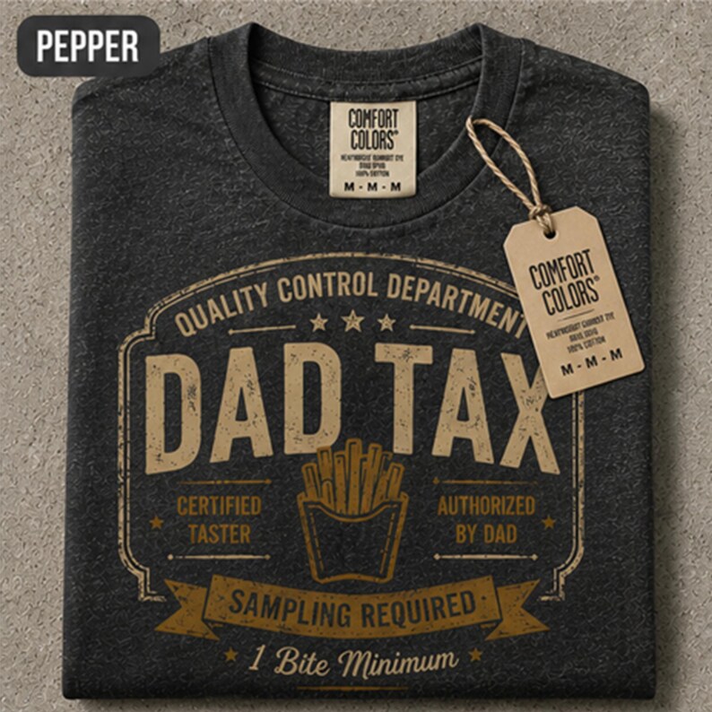 May include: A charcoal gray t-shirt with a graphic print in tan. The text reads Quality Control Department, Dad Tax, Certified Taster, Authorized By Dad, Sampling Required, and 1 Bite Minimum. A carton of french fries is centered in the design.