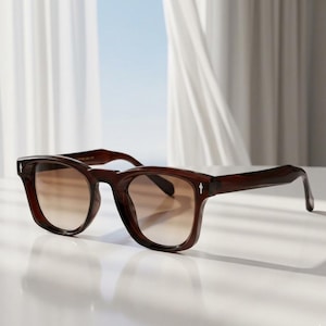 May include: Dark brown square sunglasses with gradient lenses. The frames have a small white arrow detail on the temples. The lenses transition from a darker brown at the top to a lighter brown at the bottom.