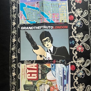 May include: Three folded paper game inserts featuring Liberty City map, Grand Theft Auto London with a character holding a firearm, and a Grand Theft Auto game cover illustration showing a person with a red telephone and a white sports car.