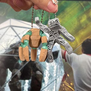Rocky and Grace keychain set inspired by Project Hail Mary hanging from a backpack as sci fi bag charms