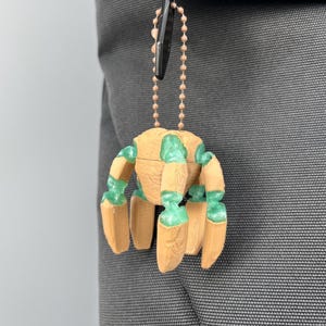 Poseable Rocky sci fi keychain charm with Eridian inspired transparent green articulated joints